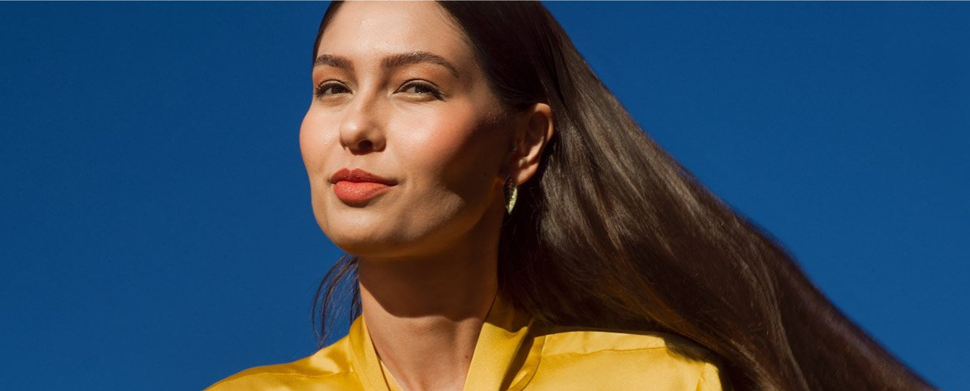 Natura haircare model on blue background.